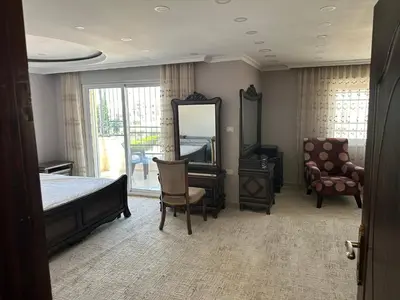 a bedroom with a bed and a mirror and a chair at شقه في اربد apartment in irbid in Irbid