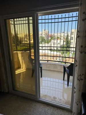a sliding glass door with a view of a balcony at شقه في اربد apartment in irbid in Irbid
