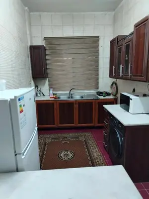 a kitchen with a sink and a dishwasher at شقة ام نوارة الحديثة الفارهة spacious economic flat in Amman