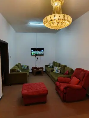 a living room with a couch and a chandelier at شقة ام نوارة الحديثة الفارهة spacious economic flat in Amman
