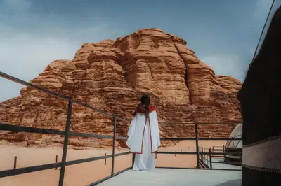 a woman standing in front of a rock formation at Aladdin Camp in Disah
