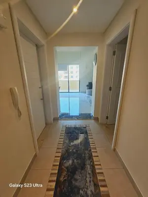 a hallway with a tile floor in a house at B36 Loft Apartment Samarah Resort in Sowayma