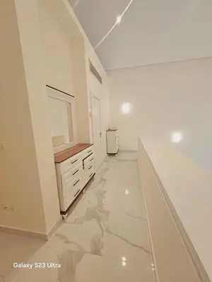 a large bathroom with a vanity and a mirror at B36 Loft Apartment Samarah Resort in Sowayma