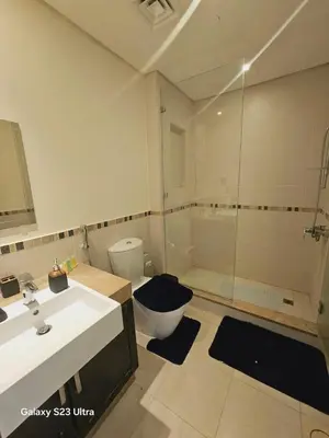a bathroom with a shower and a toilet and a sink at B36 Loft Apartment Samarah Resort in Sowayma
