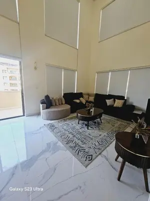 a large living room with a couch and tables at B36 Loft Apartment Samarah Resort in Sowayma