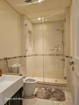 a bathroom with a shower and a toilet and a sink at B35 Samarah Resort LOFT apartment in Sowayma
