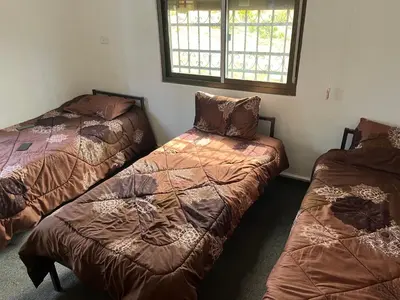 a bedroom with two beds and a window at منزل مستقل لقضاء اجمل الاوقات بجبال عجلون in Ajloun