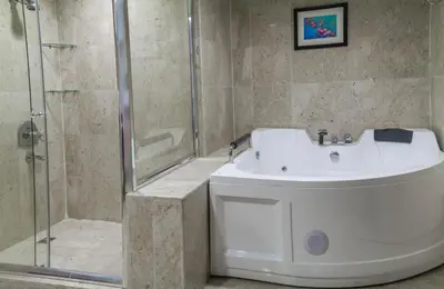 a bathroom with a white sink and a shower at Grand Days Hotel & Suites Amman in Umm Uthainah