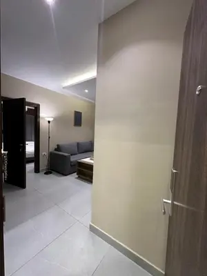 a living room with a couch and a sliding door at Chic Apartments For Rent ave2-1 in Amman