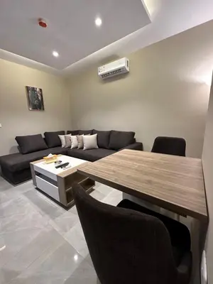 a living room with a table and a couch at Chic Apartments For Rent ave2-4 in Amman