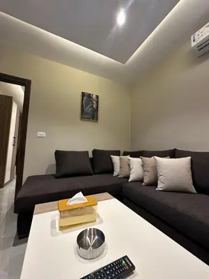 a living room with a couch and a table at Chic Apartments For Rent ave2-4 in Amman
