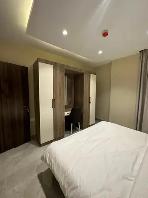 a bedroom with a large white bed and a desk at Chic Apartments For Rent ave2-4 in Amman