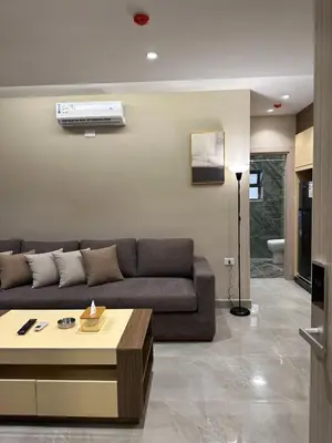 a living room with a couch and a table at Chic Apartments For Rent ave2-5 in Amman