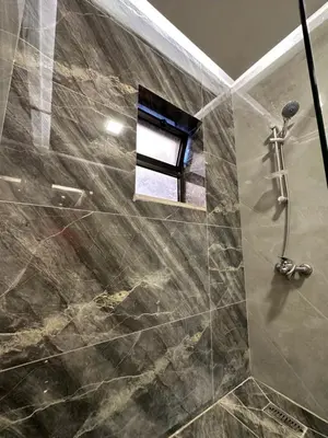 a bathroom with a shower with a glass door at Chic Apartments For Rent ave2-5 in Amman