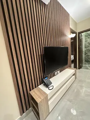 a phone sitting on a bench in a room at Chic Apartments For Rent ave2-6 in Amman