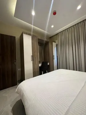 a bedroom with a large white bed and a desk at Chic Apartments For Rent ave2-6 in Amman