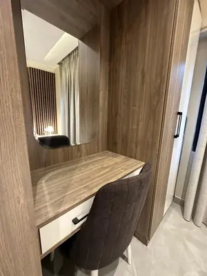 a room with a desk with a mirror and a chair at Chic Apartments For Rent ave2-6 in Amman