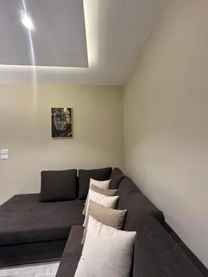 a living room with a couch with pillows at Chic Apartments For Rent ave2-6 in Amman