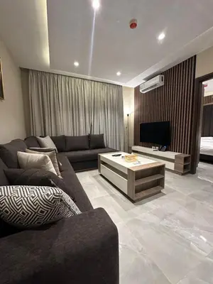 a living room with a couch and a television at Chic Apartments For Rent ave2-7 in Amman