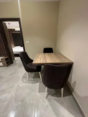 a wooden table and chairs in a room at Chic Apartments For Rent ave2-7 in Amman