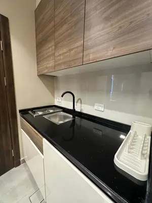 a kitchen with a sink and a black counter top at Chic Apartments For Rent ave2-7 in Amman