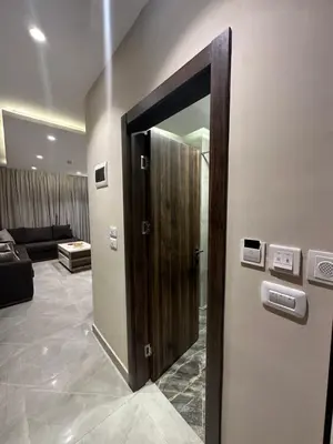 a wooden door in a room with a couch at Chic Apartments For Rent ave2-7 in Amman