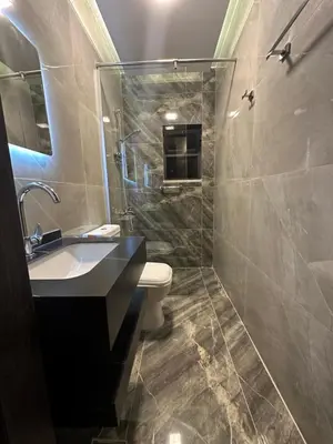 a bathroom with a sink and a toilet and a shower at Chic Apartments For Rent ave2-8 in Amman