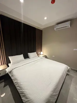 a bedroom with a large bed with white sheets at Chic Apartments For Rent ave2-8 in Amman