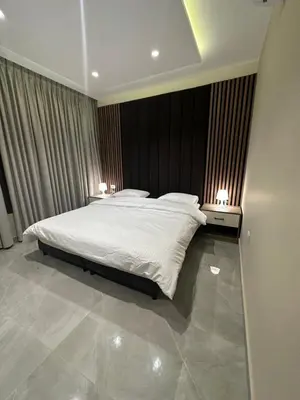 a bedroom with a large white bed with two lamps at Chic Apartments For Rent ave2-9 in Amman