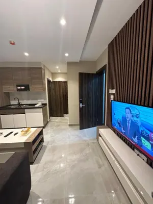 a living room with a large flat screen tv at Chic Apartments For Rent ave2-9 in Amman