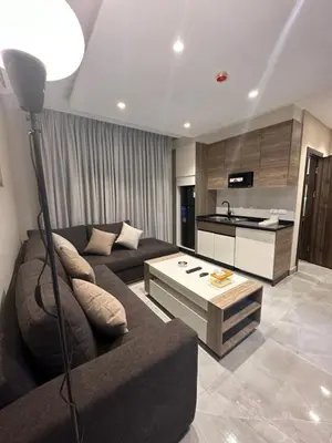 a living room with a couch and a table at Chic Apartments For Rent ave2-9 in Amman