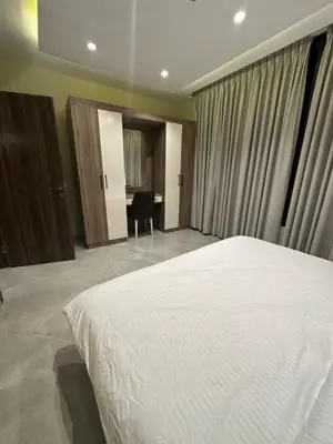 a bedroom with a white bed and a desk at Chic Apartments For Rent ave2-9 in Amman