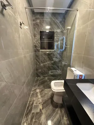 a bathroom with a toilet and a shower and a sink at Chic Apartments For Rent ave2-9 in Amman