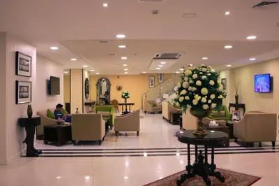 a lobby of a hospital with a person sitting in a chair at City Rose Hotel Suites in Amman
