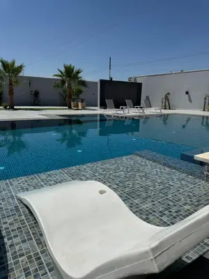a swimming pool with a tub in the middle at Sol Villa By Seahorse in Al Rama