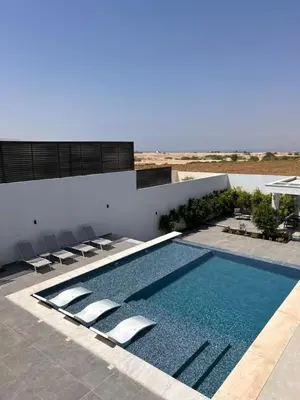 a swimming pool on the side of a building at Shomani by Seahorse in Al Rama