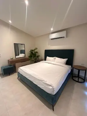 a bedroom with a large bed and a mirror at Shomani by Seahorse in Al Rama