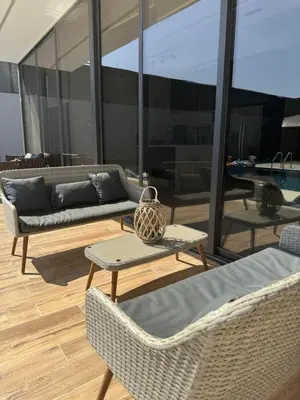 a patio with a couch and chairs and a table at Maria La Rosa By Seahorse in Al Baḩḩāth