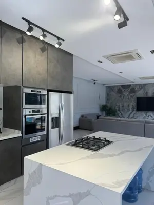 a kitchen with a white counter top and a stove at Maria La Rosa By Seahorse in Al Baḩḩāth