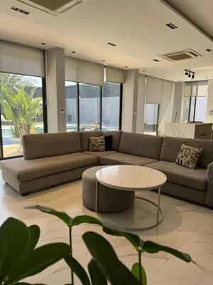 a living room with a couch and a table at Maria La Rosa By Seahorse in Al Baḩḩāth