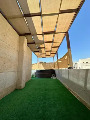 an external view of a building with green grass at Rooftop pool with terraces F-R in Amman