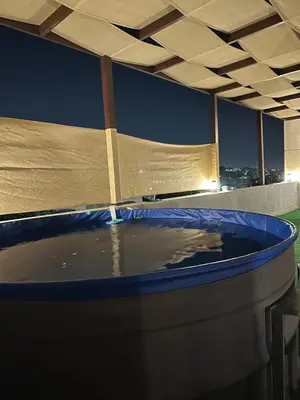 a hot tub with water in it on a roof at Rooftop pool with terraces F-R in Amman
