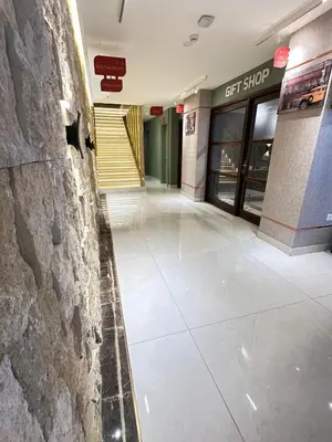 a lobby of a building with a sign on the wall at Londrina Hotel in Amman