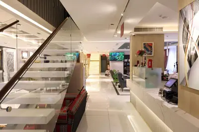 an office lobby with white stairs and a hallway at Londrina Hotel in Amman