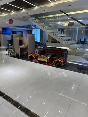 an empty airport terminal with a waiting room with a table at Londrina Hotel in Amman