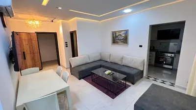 a living room with a couch and a table at شقة روف بعرفتين اطلالة ساحرة عمو سامي 21 in Amman