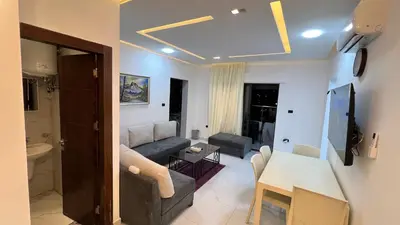 a living room with a couch and a table at شقة روف بعرفتين اطلالة ساحرة عمو سامي 21 in Amman