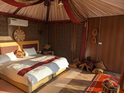 a bedroom with a bed in a tent at Desert Sand Camp in Disah