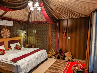 a bedroom with a bed in a tent at Desert Sand Camp in Disah