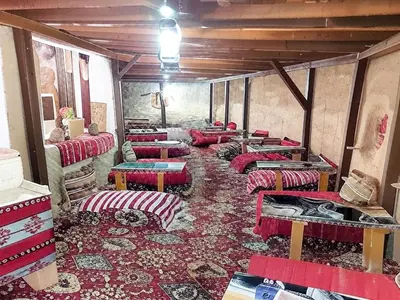 a room with many chairs and tables in a room at Desert Sand Camp in Disah